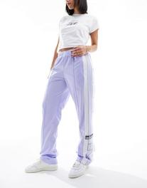 Oferta de Adidas Originals adibreak trousers in lilac por $75 en asos